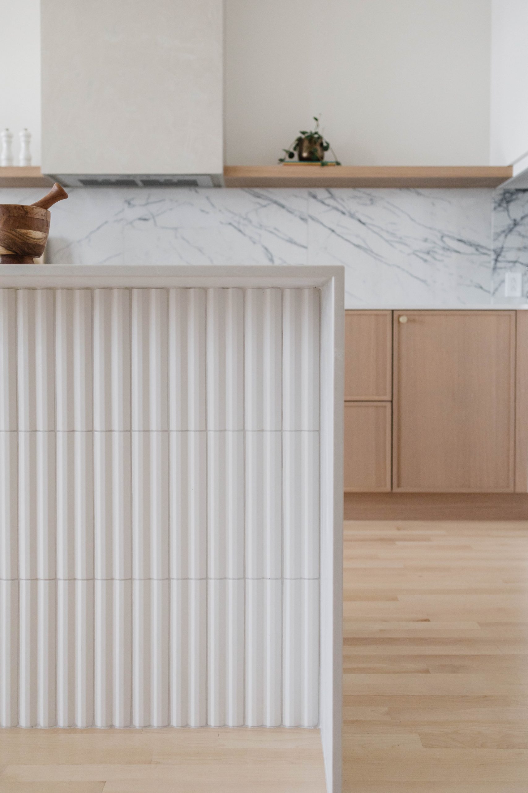 White fluted island and oak cabinets, De Lorimier kitchen